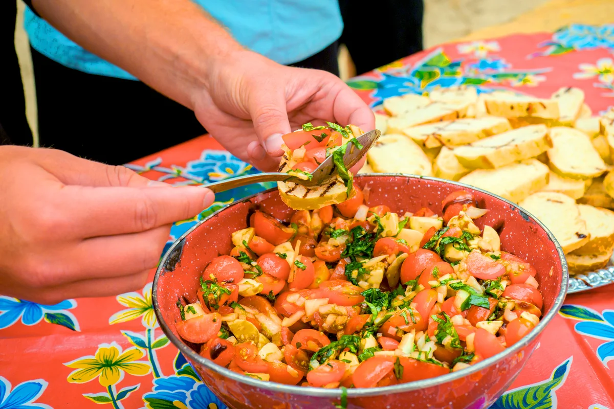 Outdoor cooking, caprese salad with tomatoes and mozzarella cheese on bruschetta
