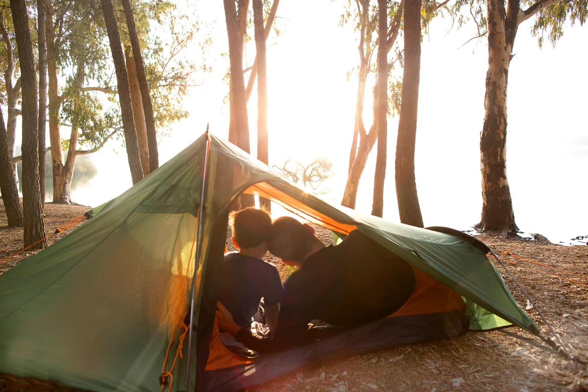 Dad and son in tent in early morning