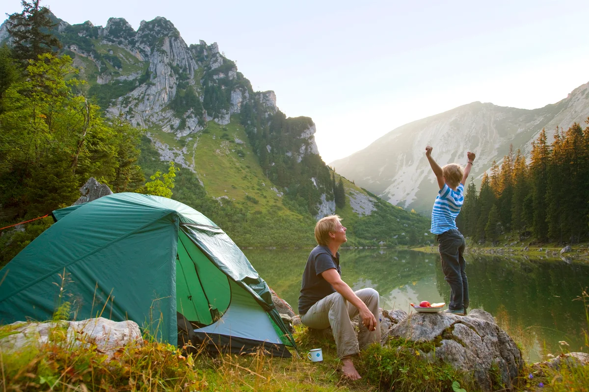 Father and son relaxing at campsite