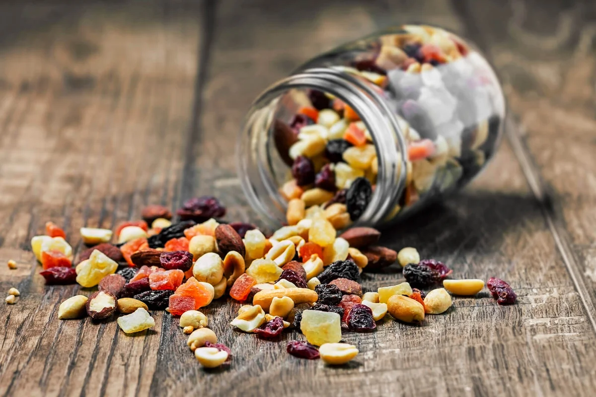 Trail mix in a jar on wooden background