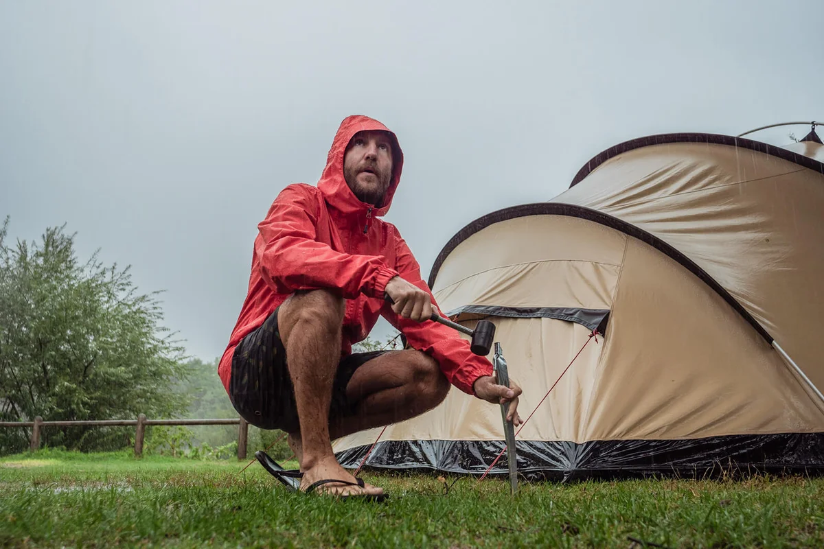 Man caught in a rainstorm while camping