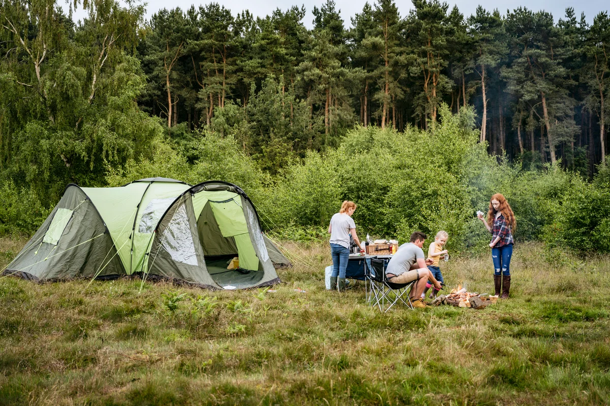 Family with two children cooking on camping trip