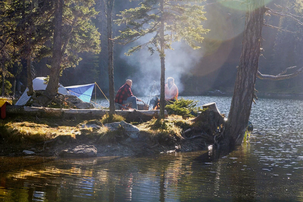 Man and woman camping on small island