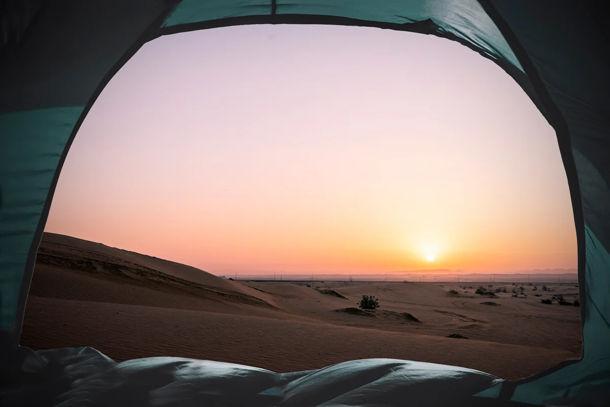 Scenic View Of Dunes Seen Through Tent On Sand Against Clear Sky During