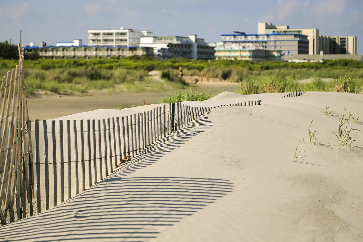 Sand dunes, fence, and hotels around Wildwood, NJ