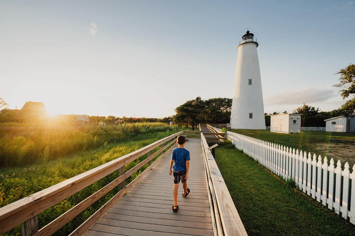Child walking towards Ocracoke Island lighthouse
