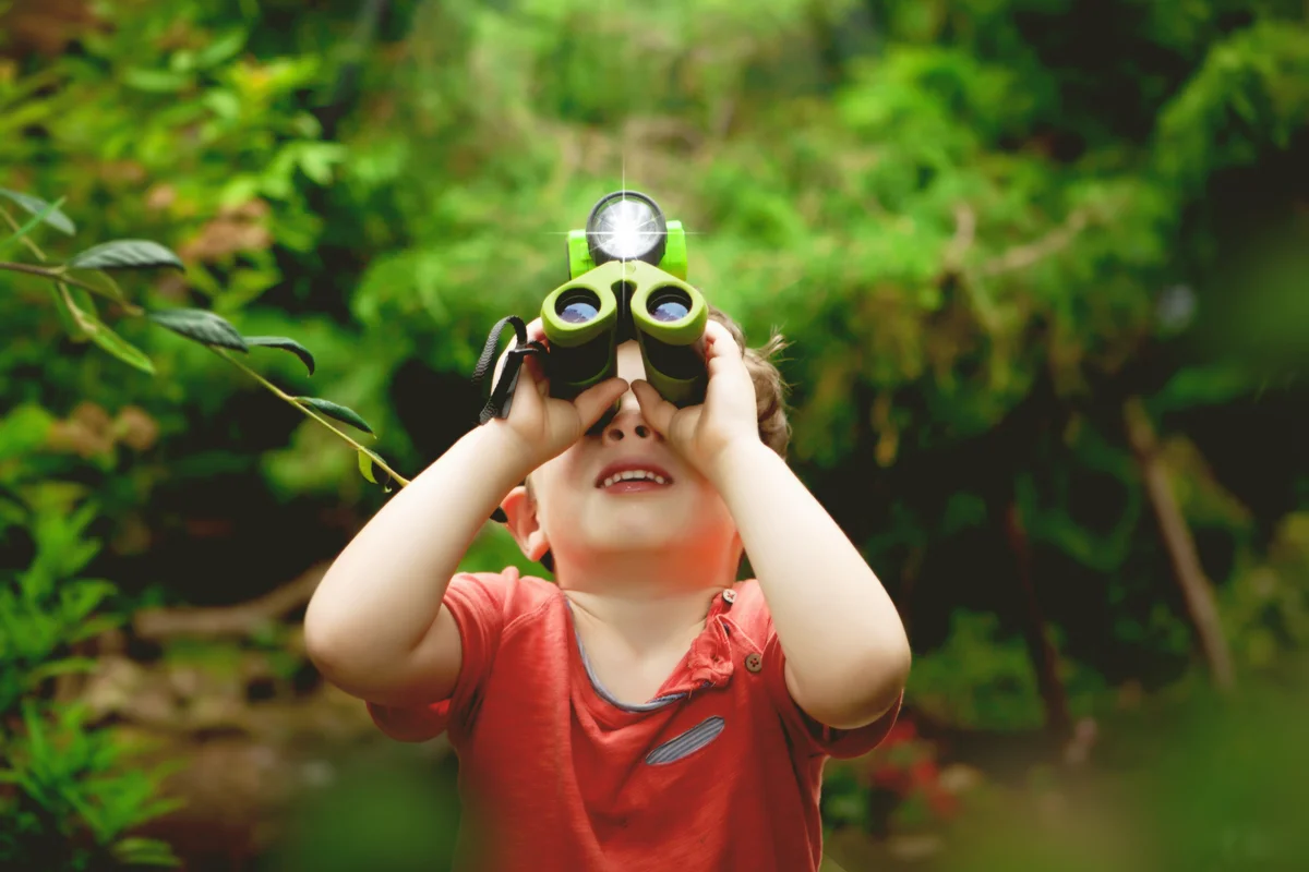 Boy binoculars looking outdoors