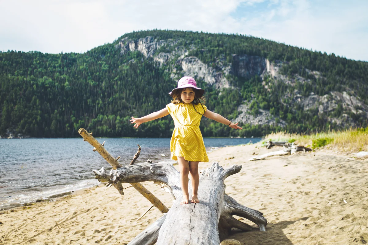 Girl Standing At Beach Against Sky