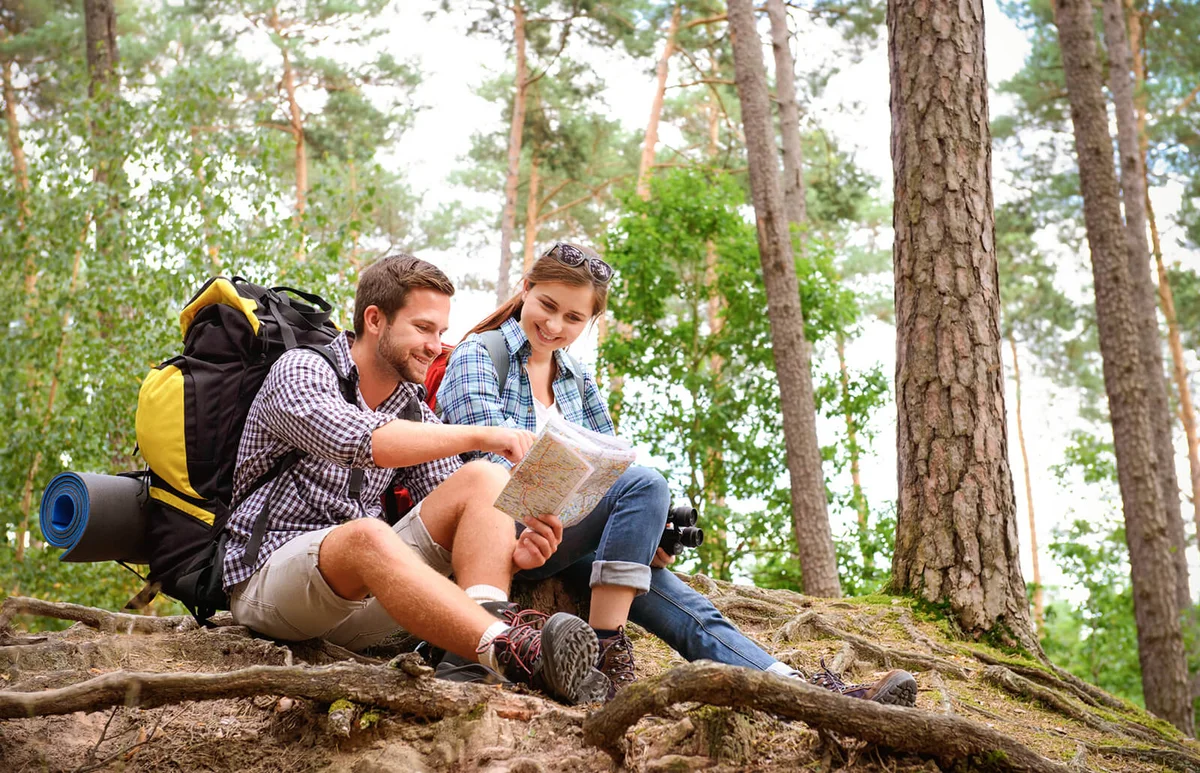Happy couple going on a hike together in a forest