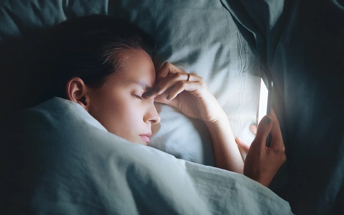 Stressed Woman Sleeping On Bed At Home
