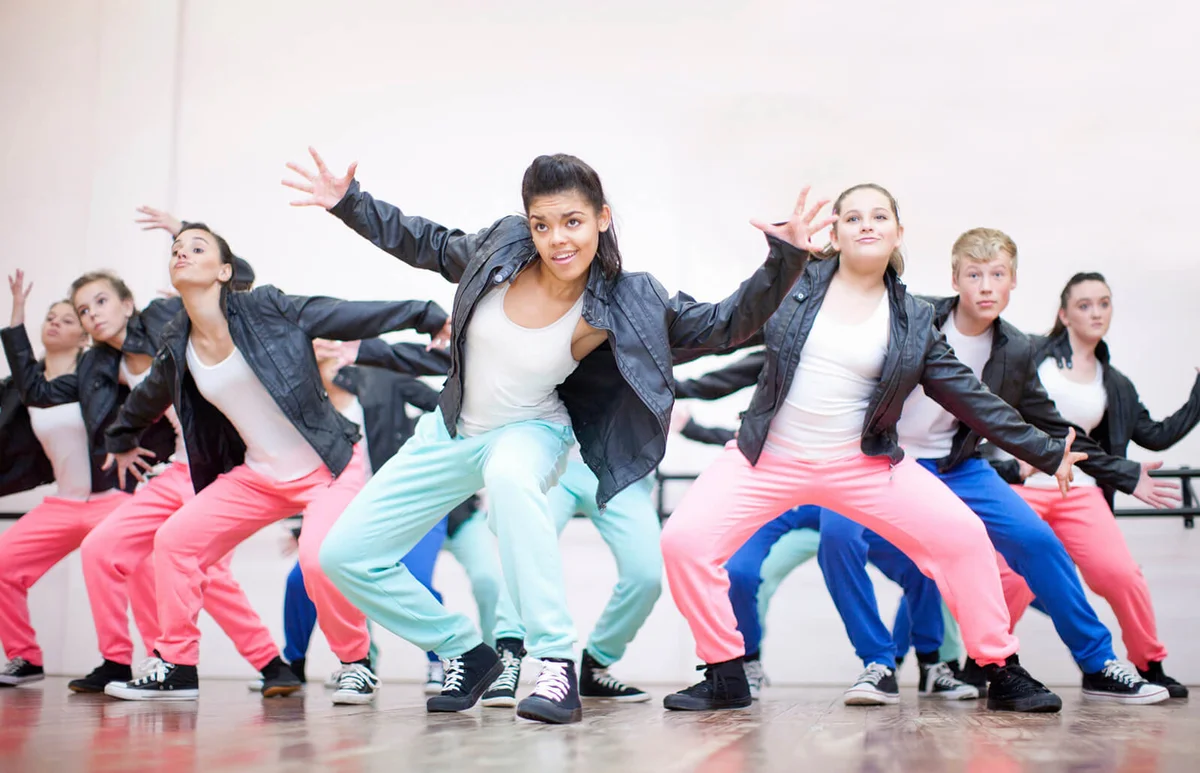 Large group of teenagers dancing in studio