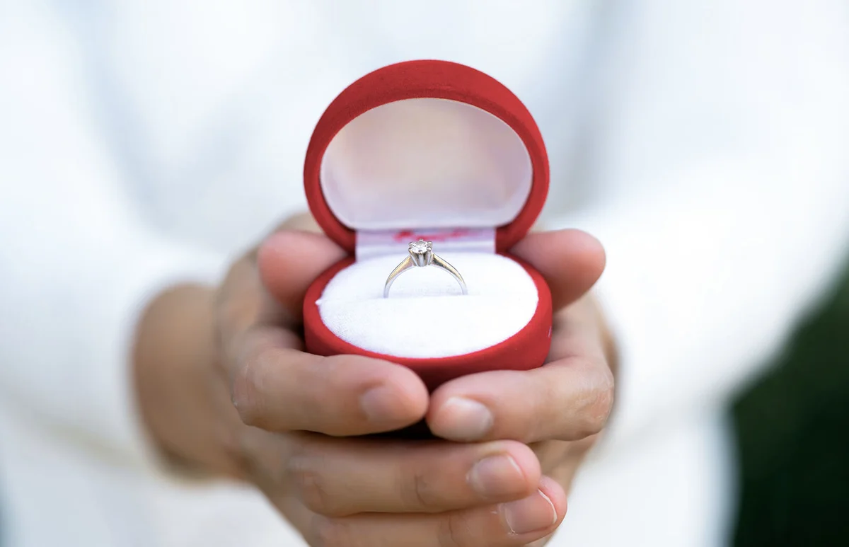 man showing engagement ring