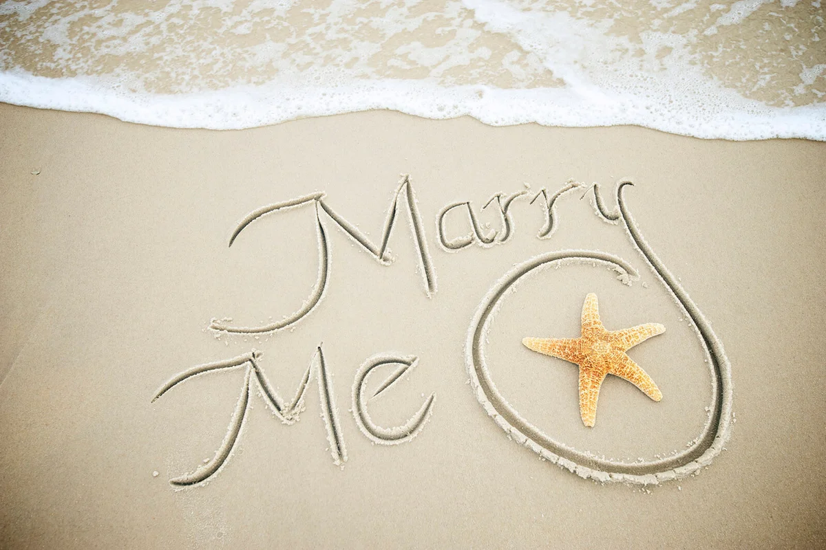 Marry Me Message Handwritten in Sand