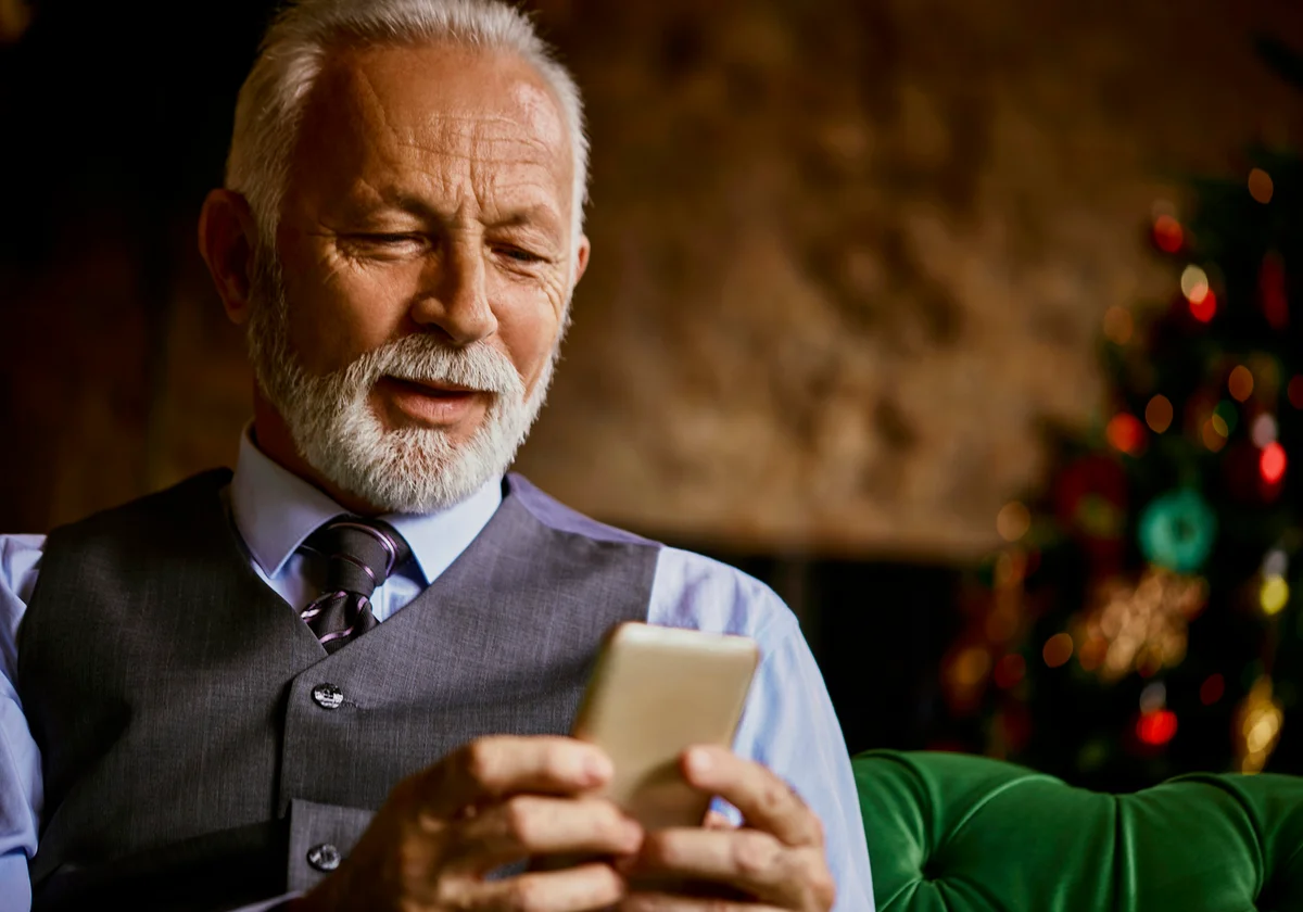 Elegant senior man using cell phone