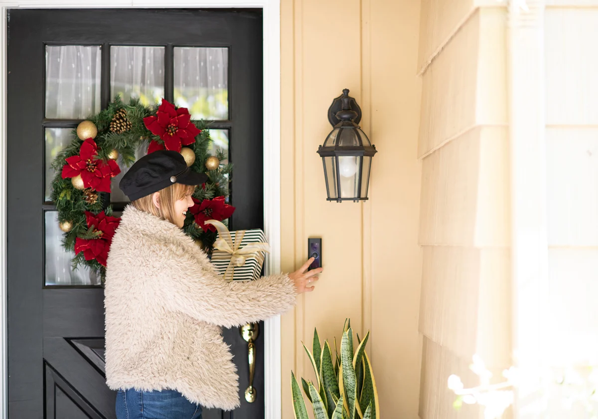 Woman With Gift Rings Doorbell