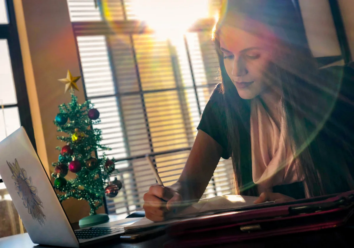 Woman journaling during the holidays