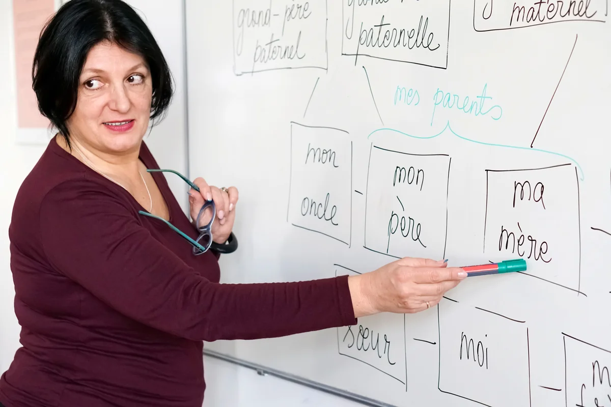 woman teaching french at whiteboard