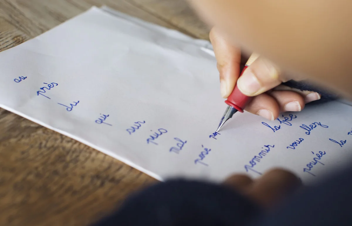 Child writing in cursive on paper