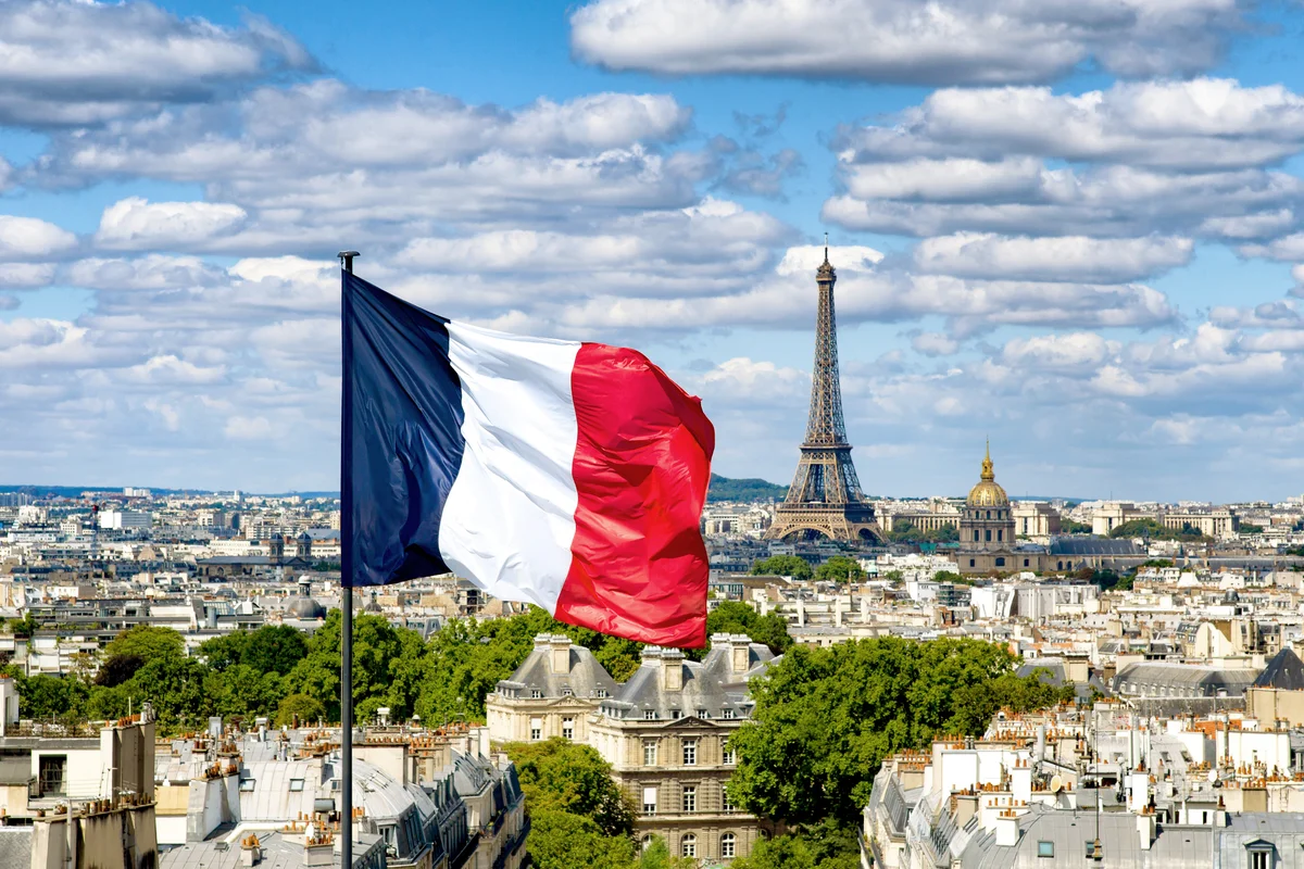 French flag with Paris on the background