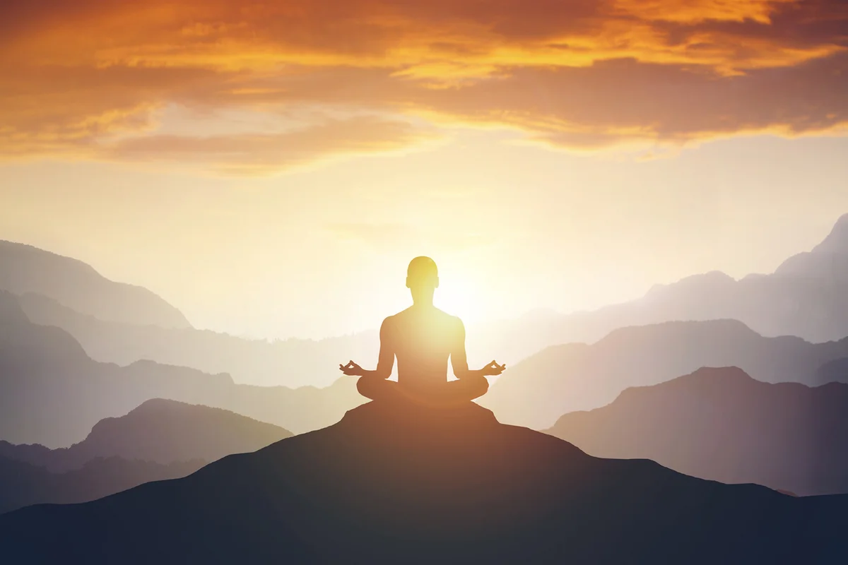 Silhouette of the meditation man on the mountain