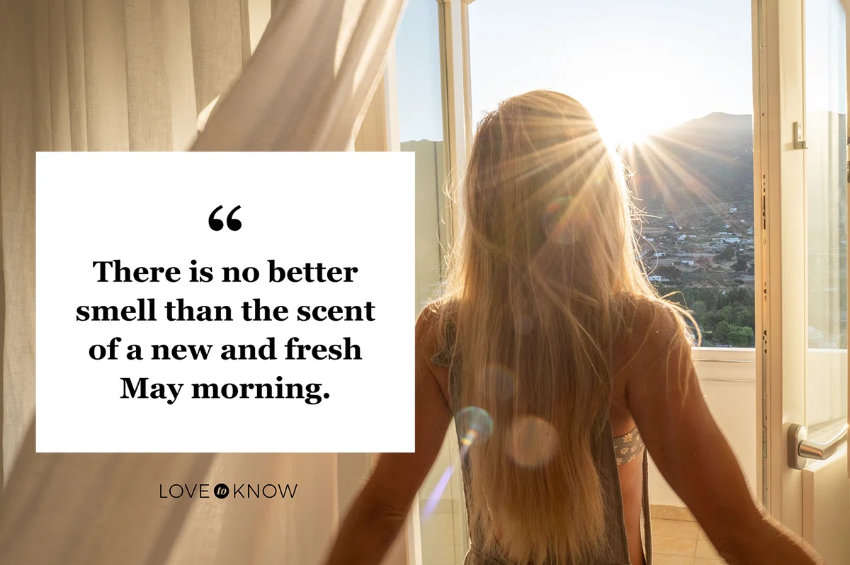 Woman opening the window at sunrise