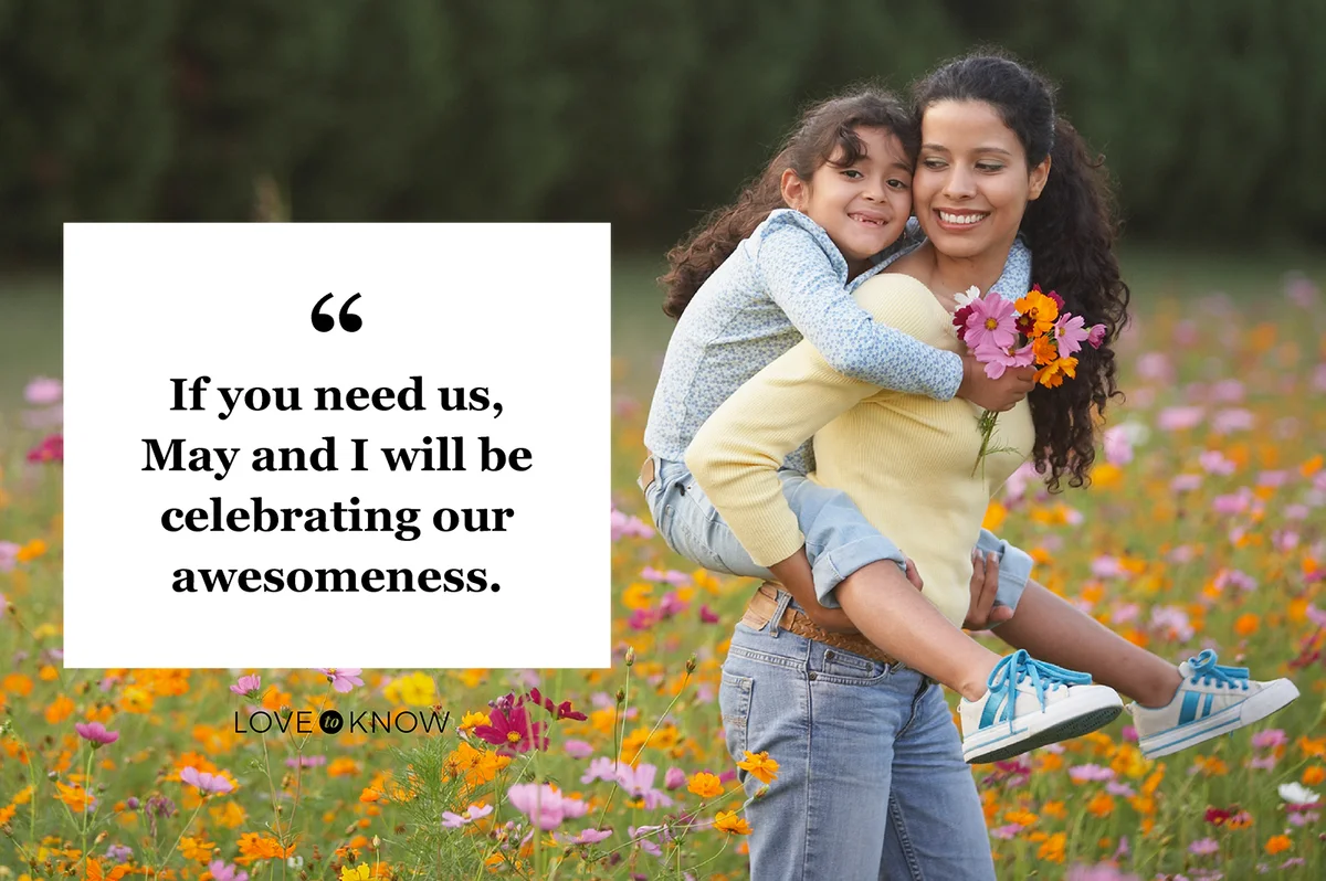 Mother giving daughter piggy back ride in field of flowers