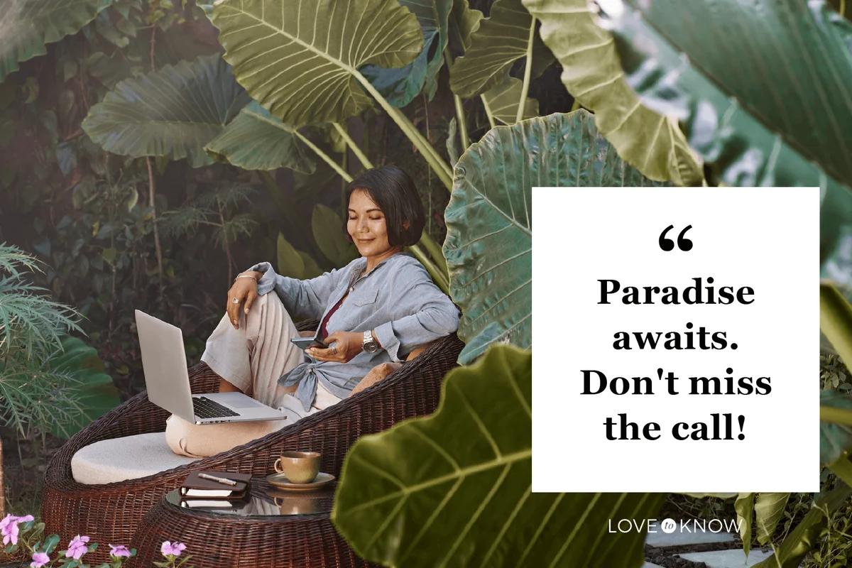 woman working from home sitting in garden furniture surrounded by tropical plants,