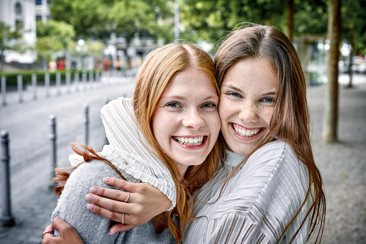 Two young women hugging and smiling