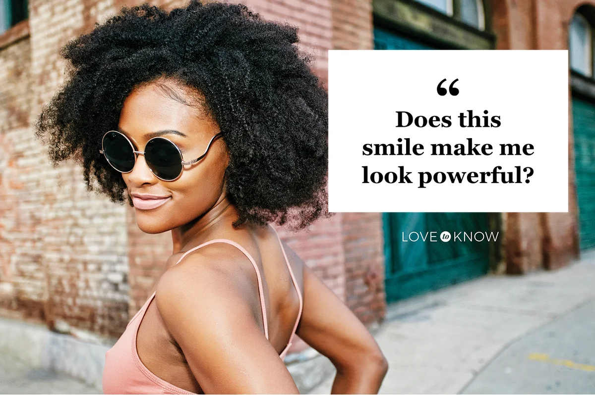 Woman smiling near corner of brick building