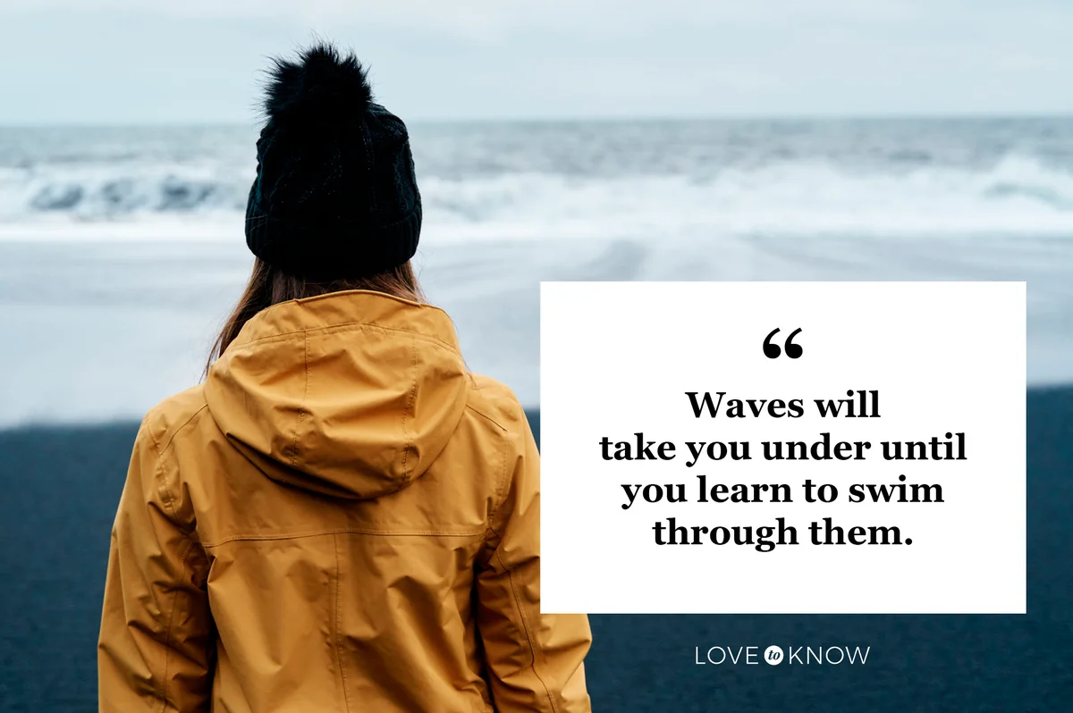 woman looking at ocean waves on a stormy day