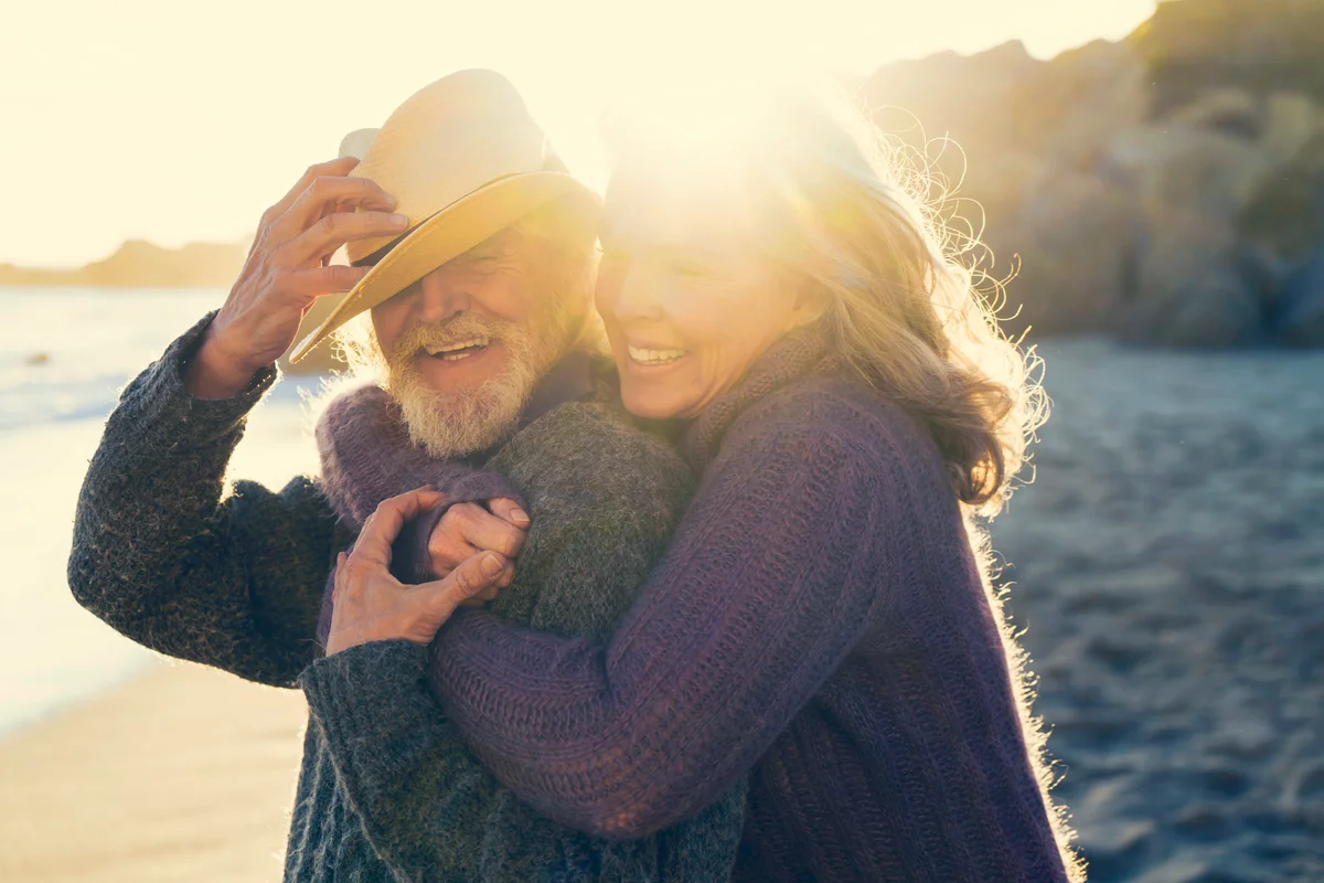 Happy senior couple embracing on sunny day