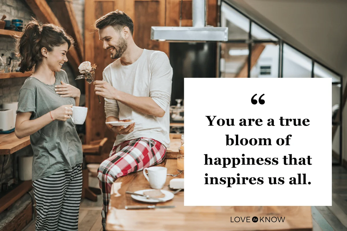 Surprised woman enjoying while receiving a rose from her boyfriend during coffee time at home.