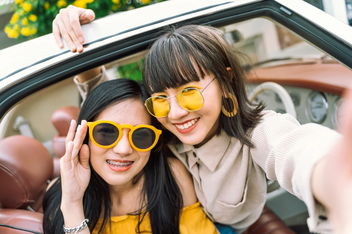 Young women taking a selfie together on road trip