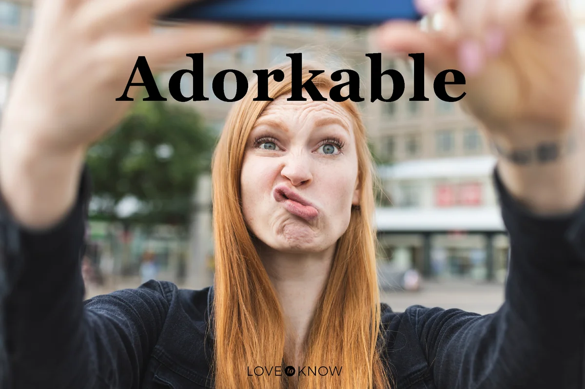 Redheaded young woman pouting mouth while taking selfie