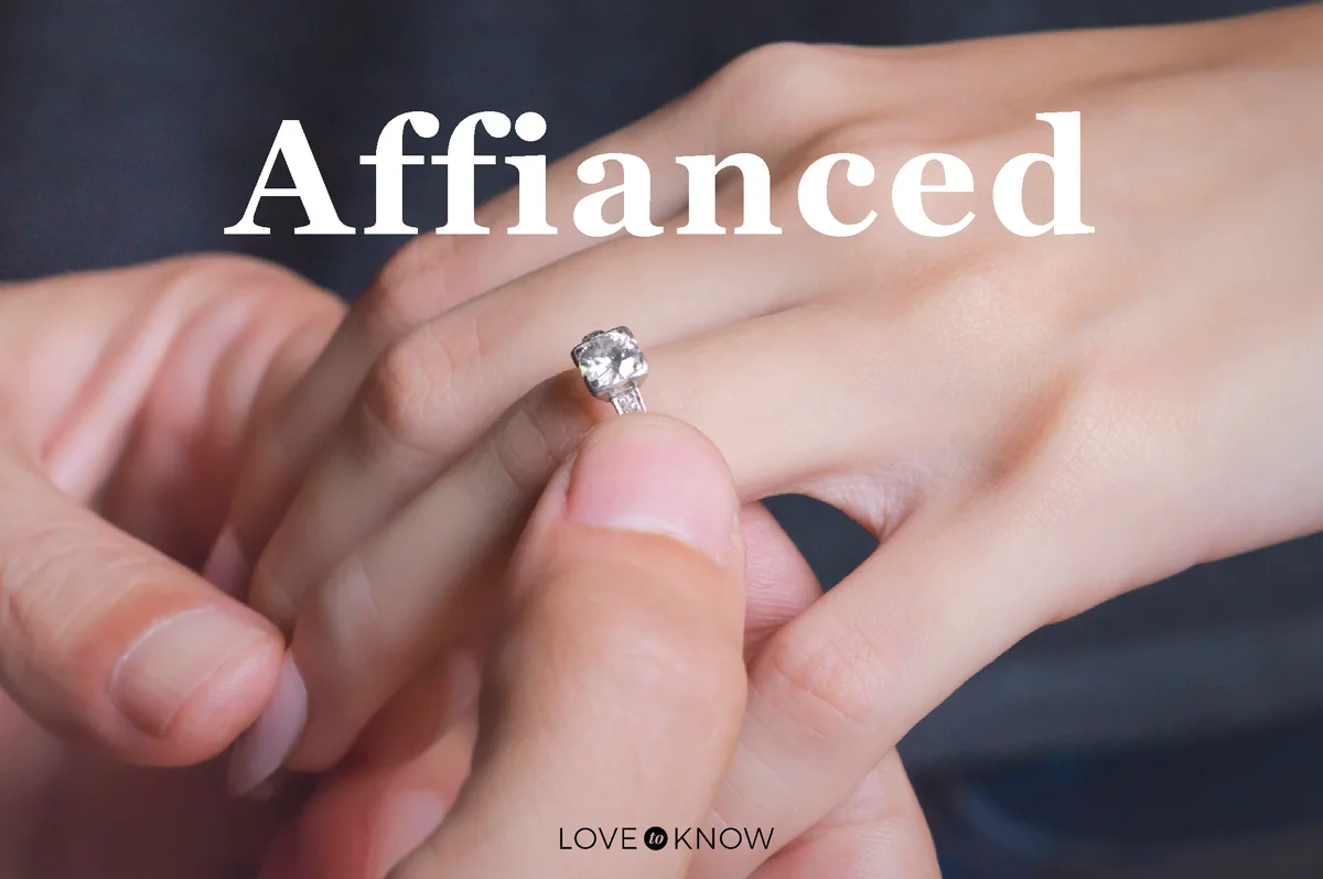 Man putting engagement ring on his girlfriend’s finger