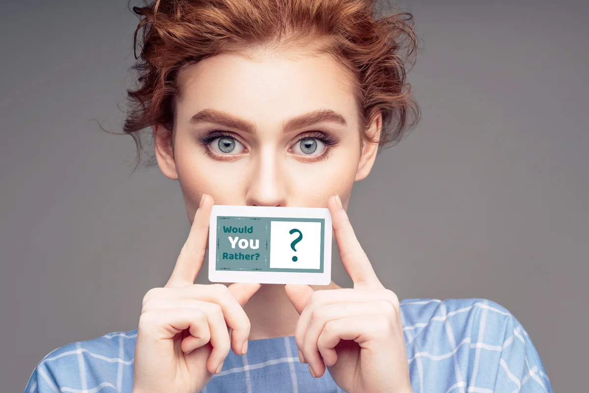 Young woman holding a would you rather card game