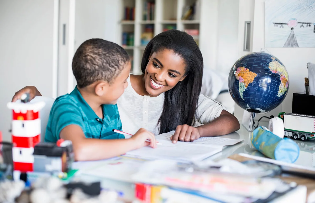Mother helping son in doing homework
