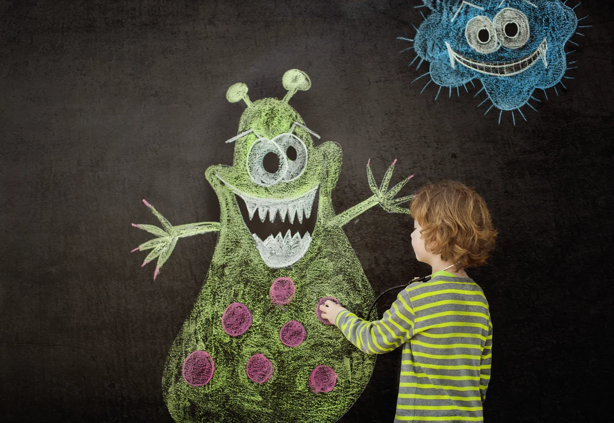 Little boy drawing a virus on blackboard