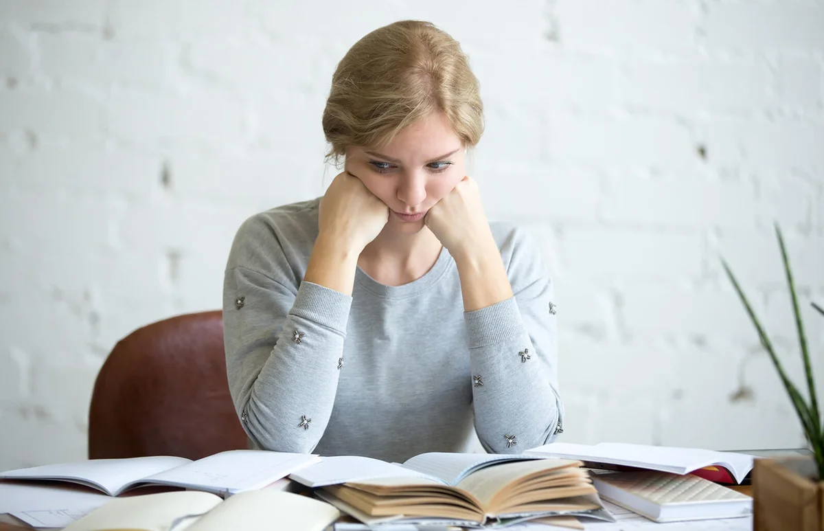 tired student woman at the desk
