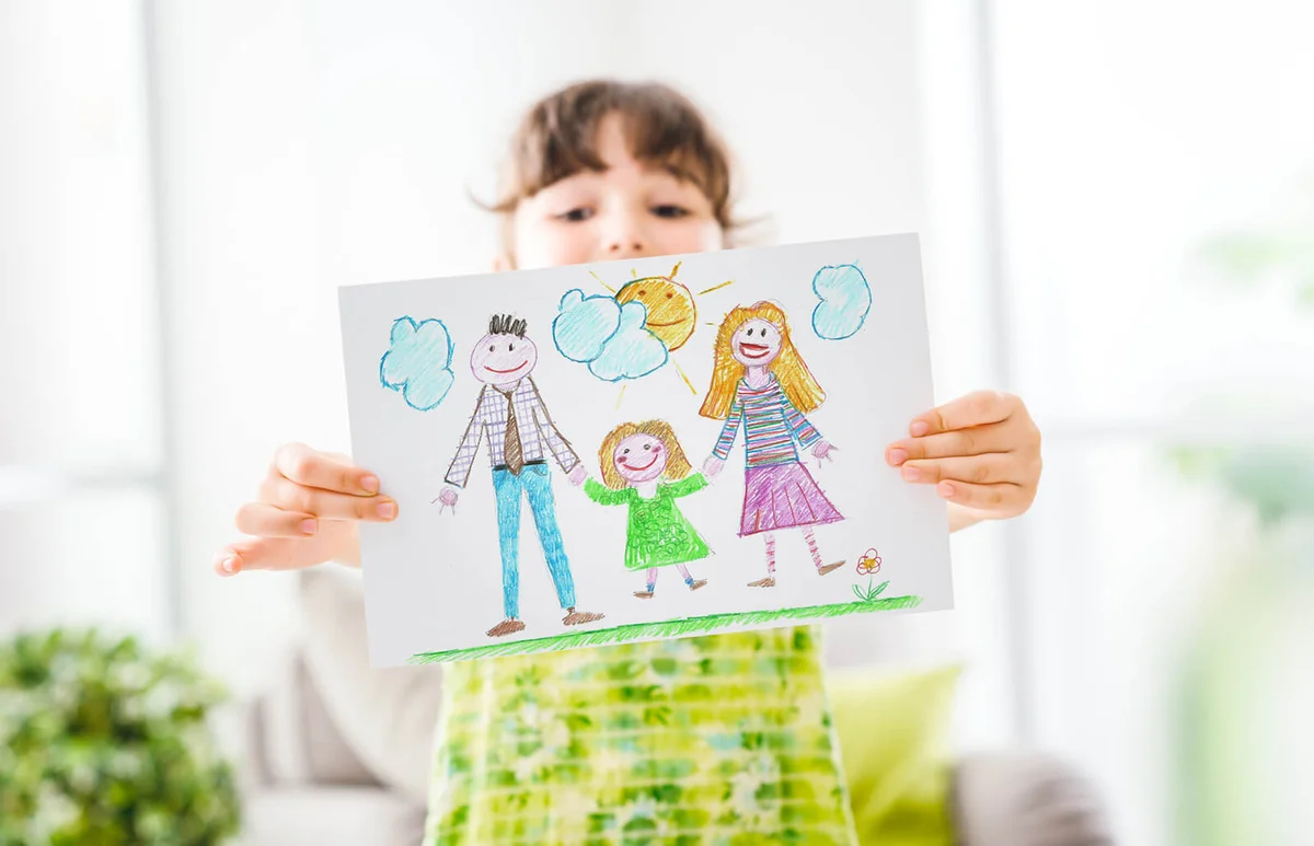 Cute young girl peeking behind a draw of her family