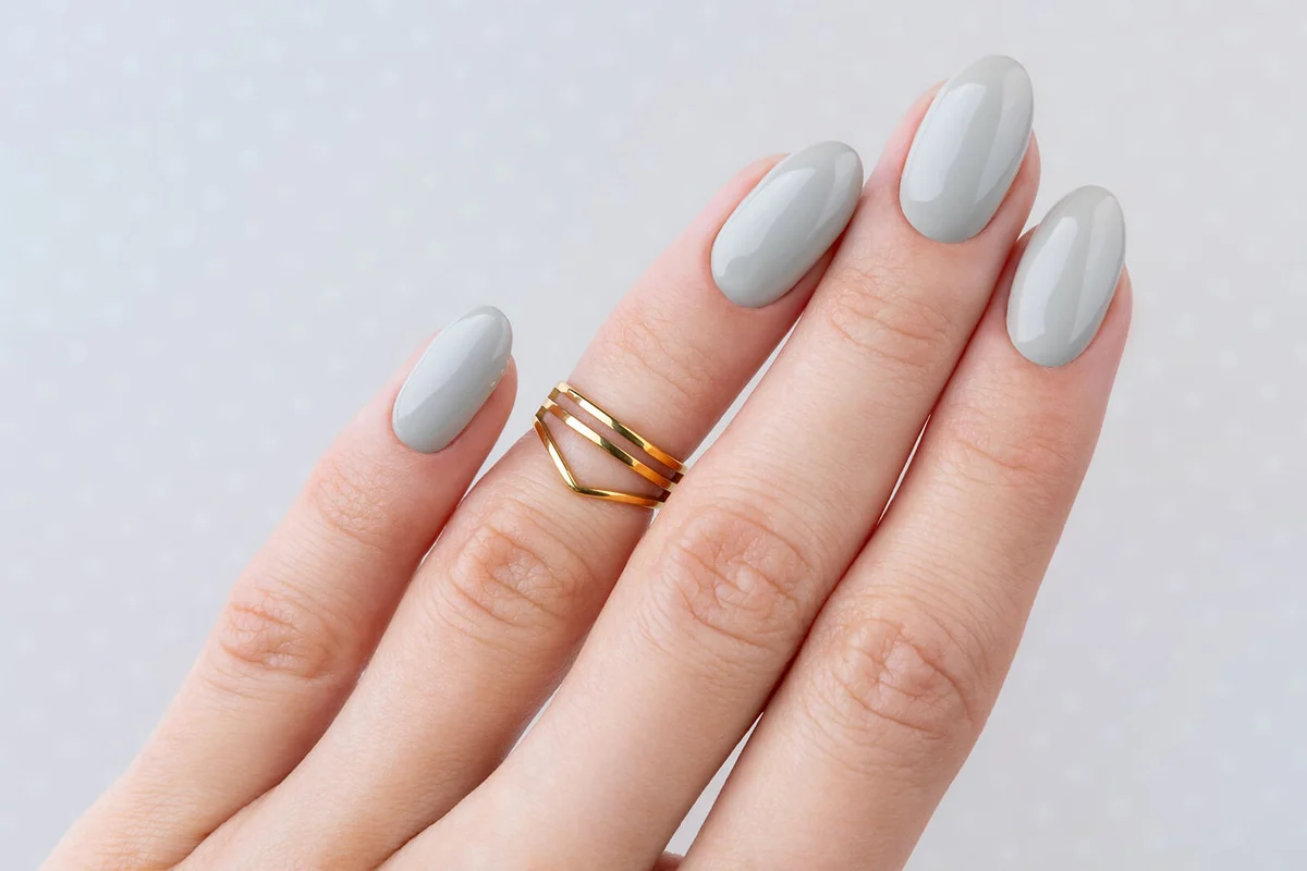 Beautiful womans hand with manicure close up on polka dot background