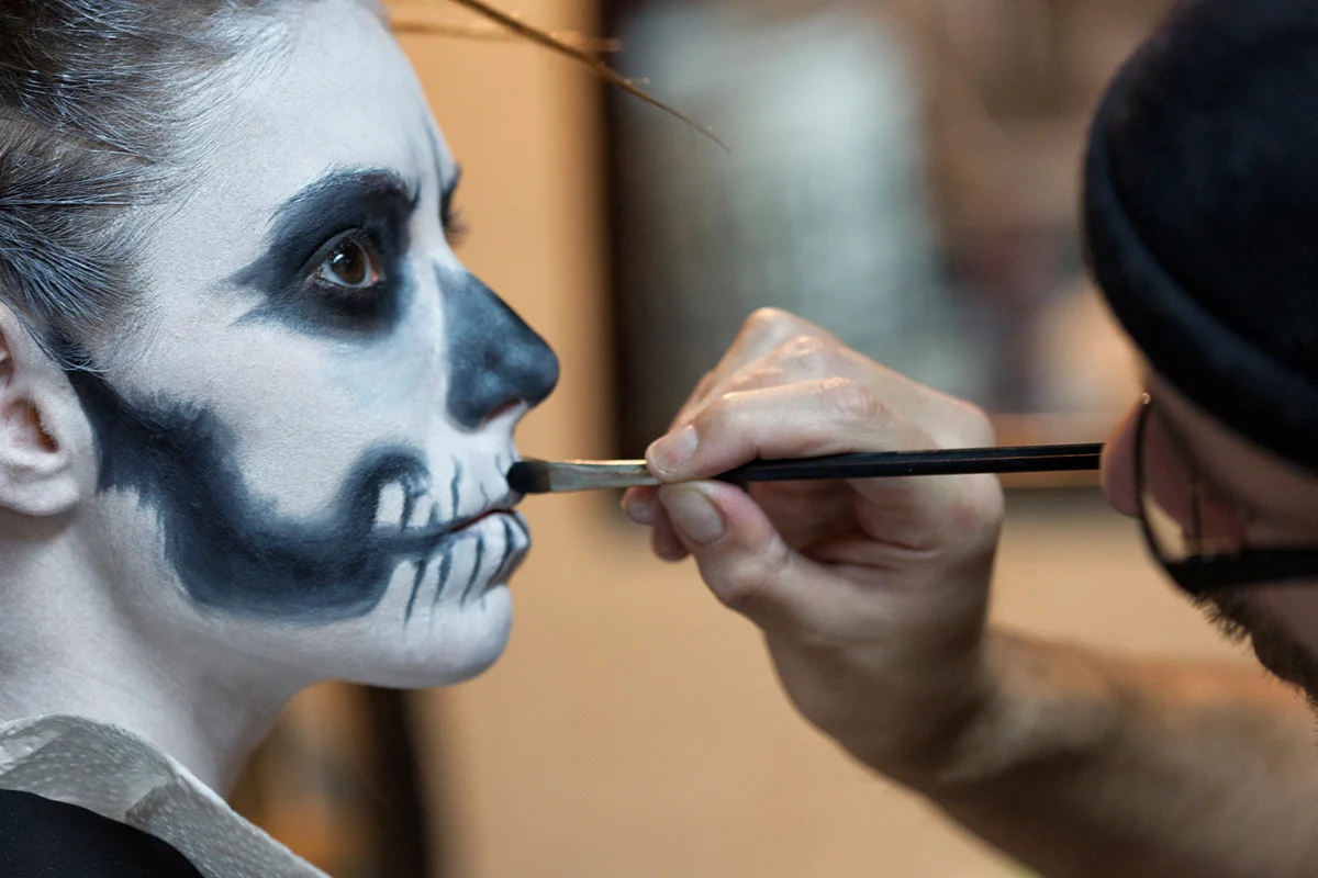 Makeup Artist applying Skeleton Makeup on a Woman