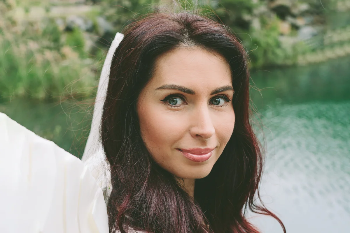 model with angel wings and in a white dress and glossy lips