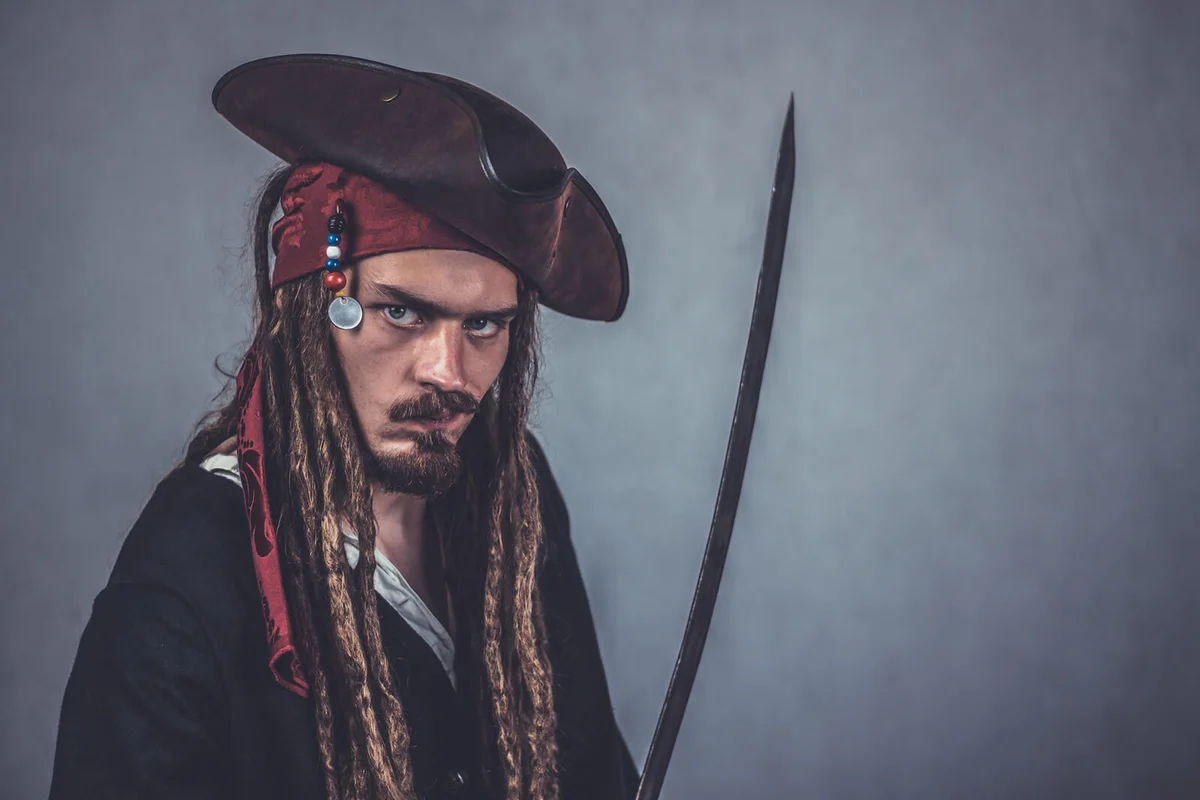 Young Man In Costume Holding Sword