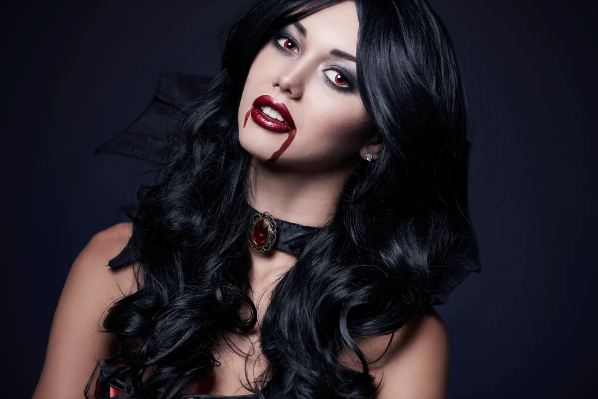 Woman vampire with blood on lips