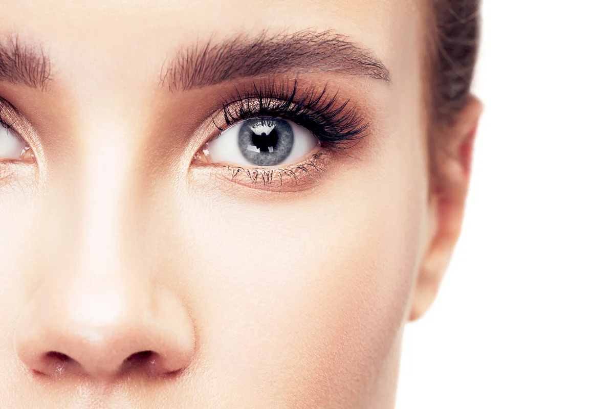 Woman with blue eyes with orange eye shadow