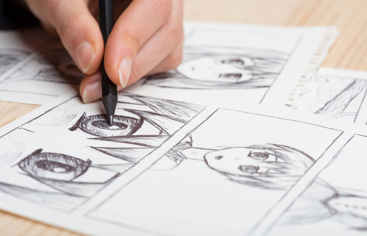 Artist drawing an anime comic book in a studio