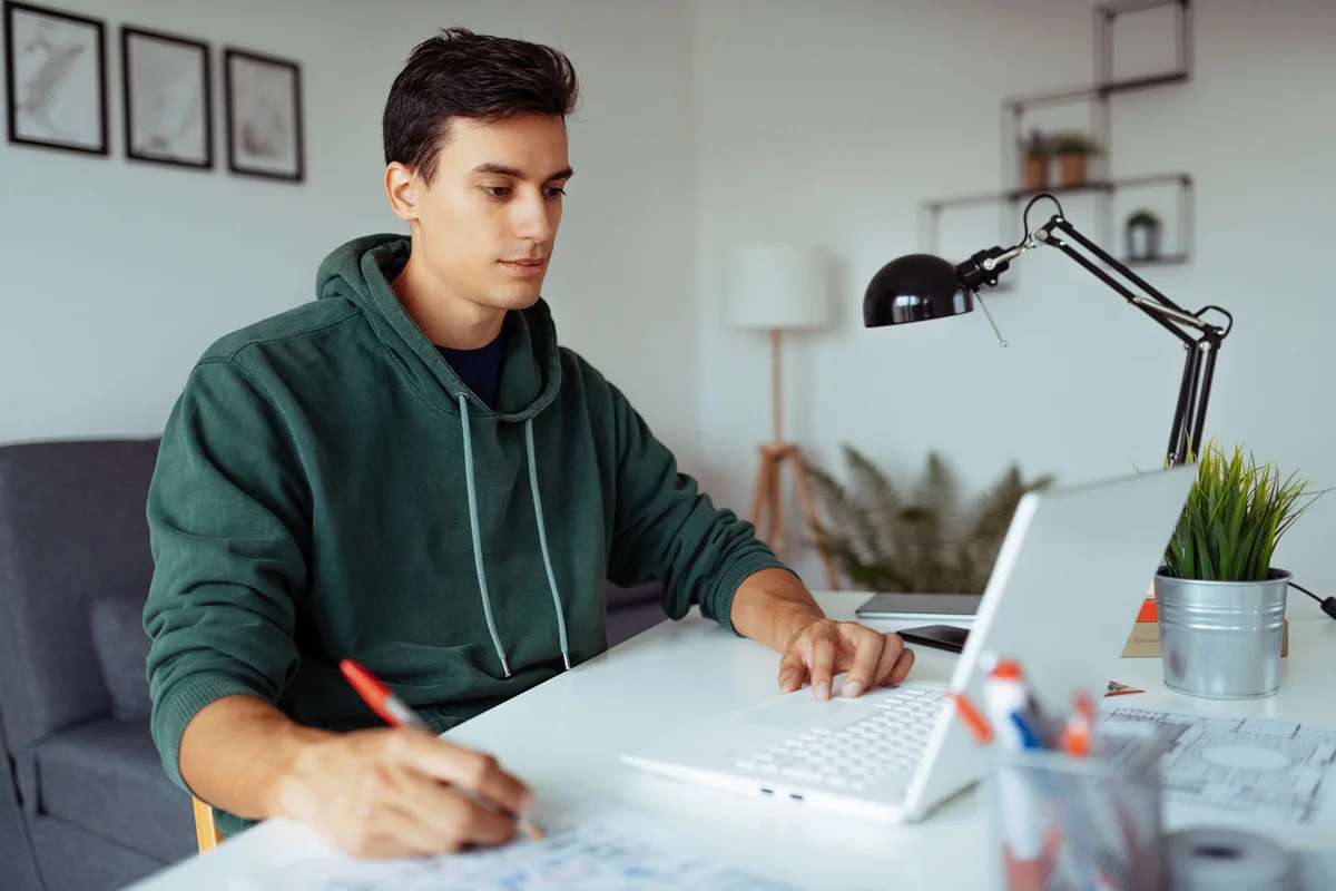 man in front of laptop attending online classes