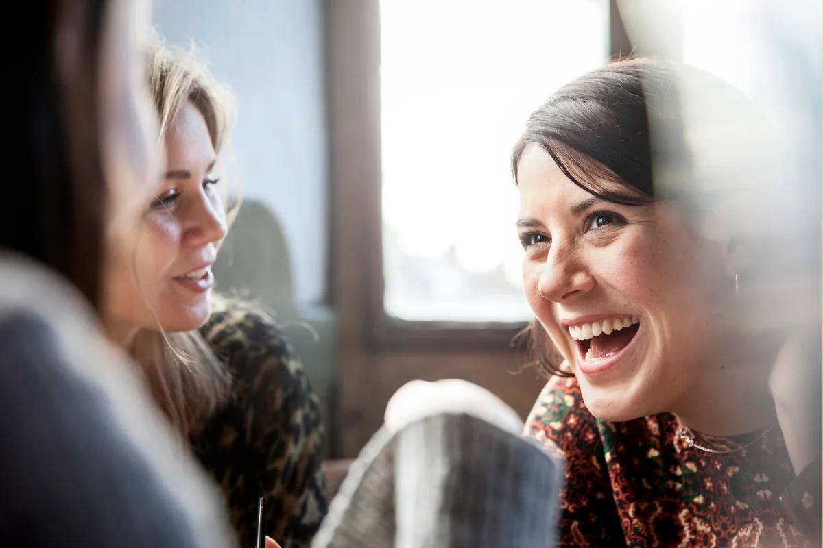 young women talking and having a good time inside