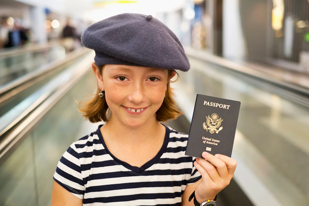 Girl holding passport in airport